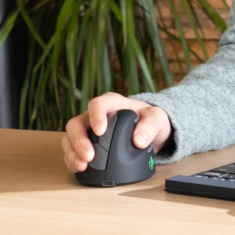 Hand resting on an HE Break Mouse to show the upright grip position