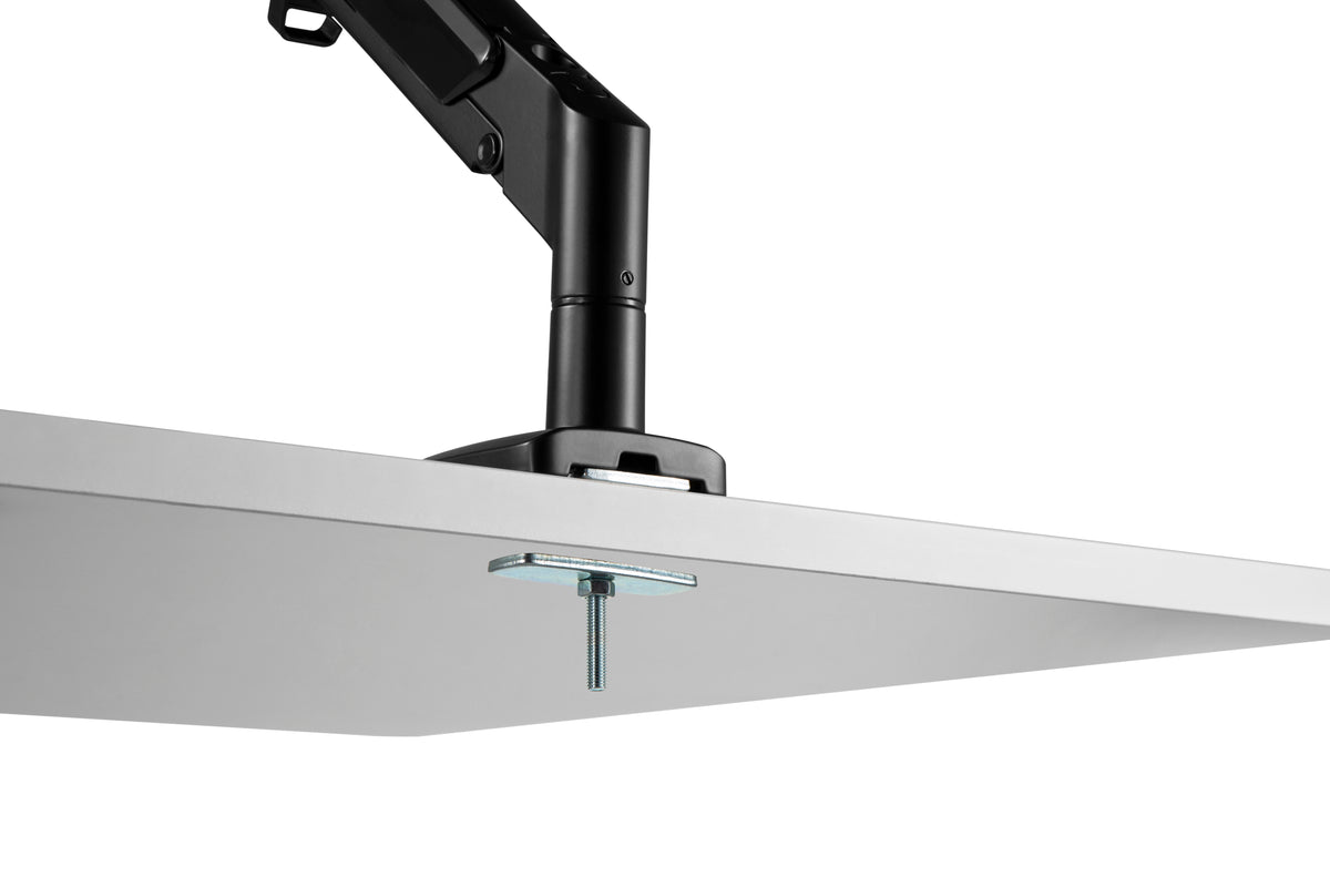 Underside view of the LCD monitor arm grommet mount fitted through a desk