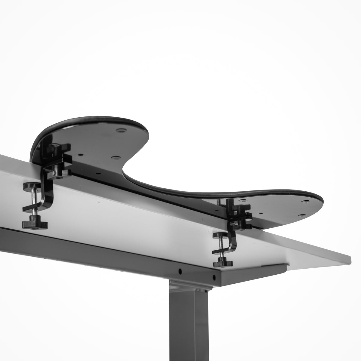 Arm support Pro Ultra Slim shown clamped to the edge of a desk