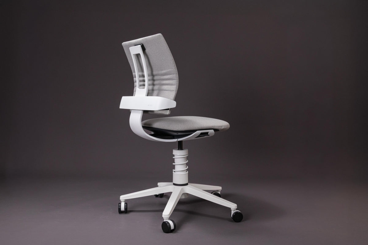 3Dee active chair with white frame and grey upholstery, side view against a dark background