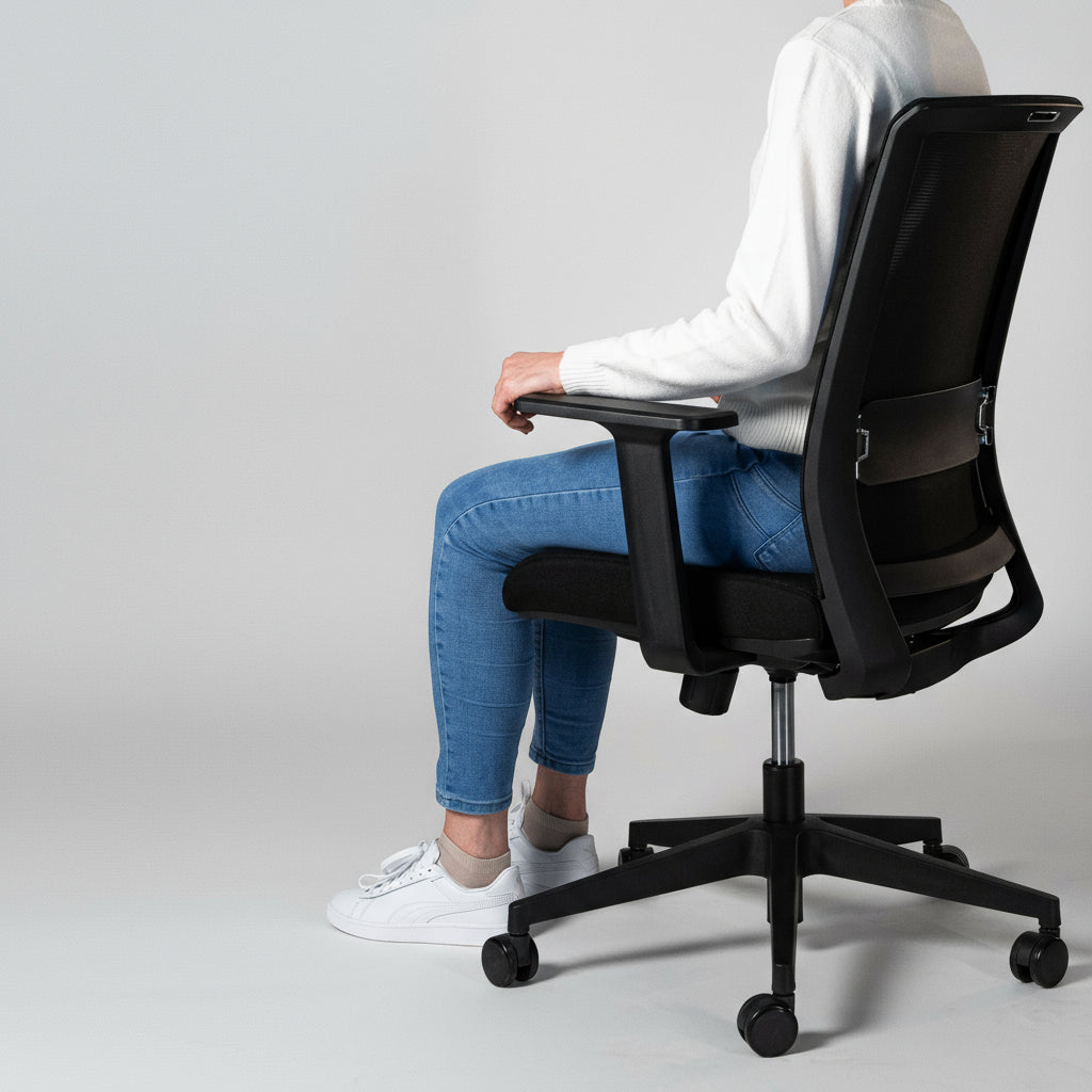 Woman seated on a Kasper Light office chair, viewed from the side