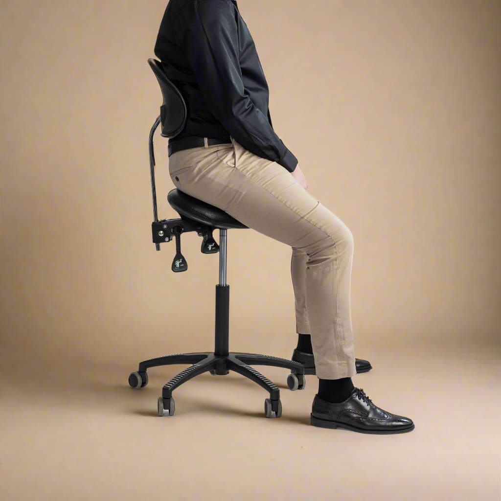 Man seated on a Lenni saddle chair with back support at a desk