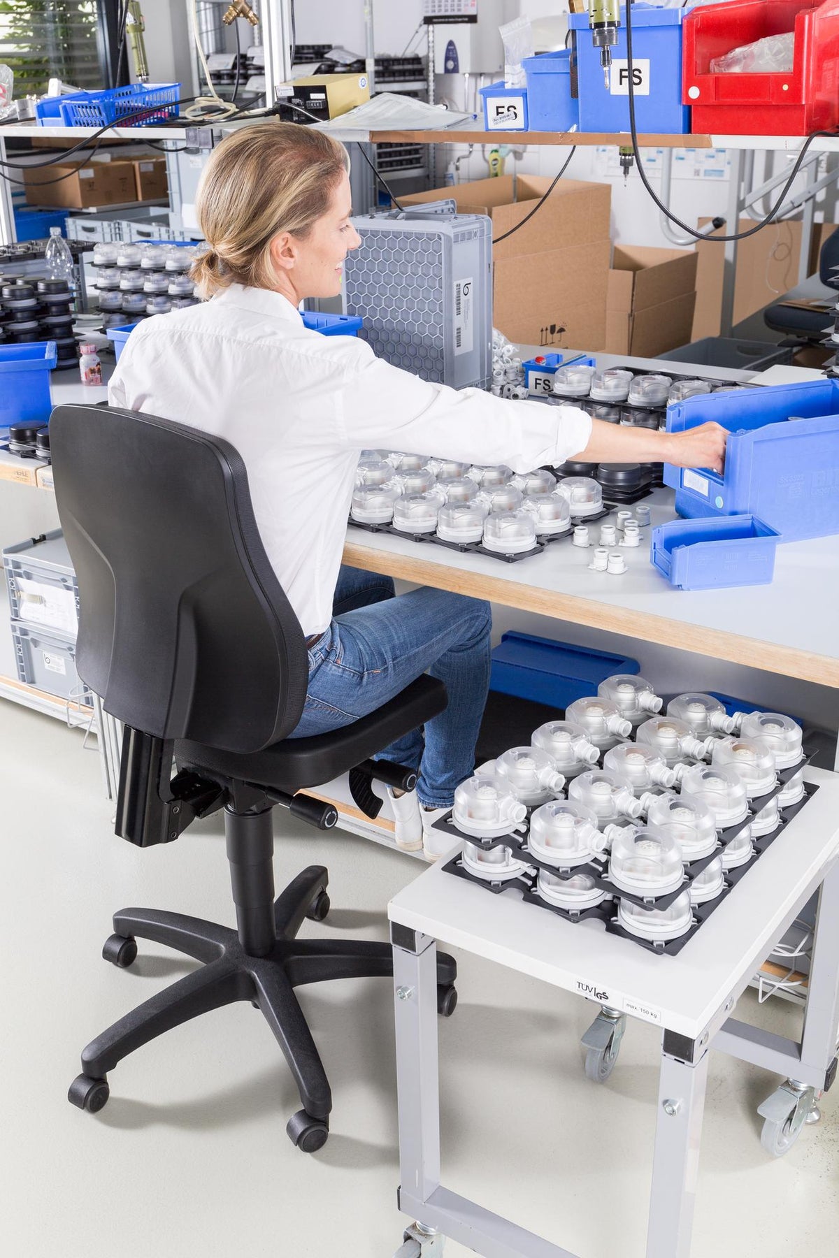 Woman working at a laboratory bench seated on an All-In-One Trend 3 work chair