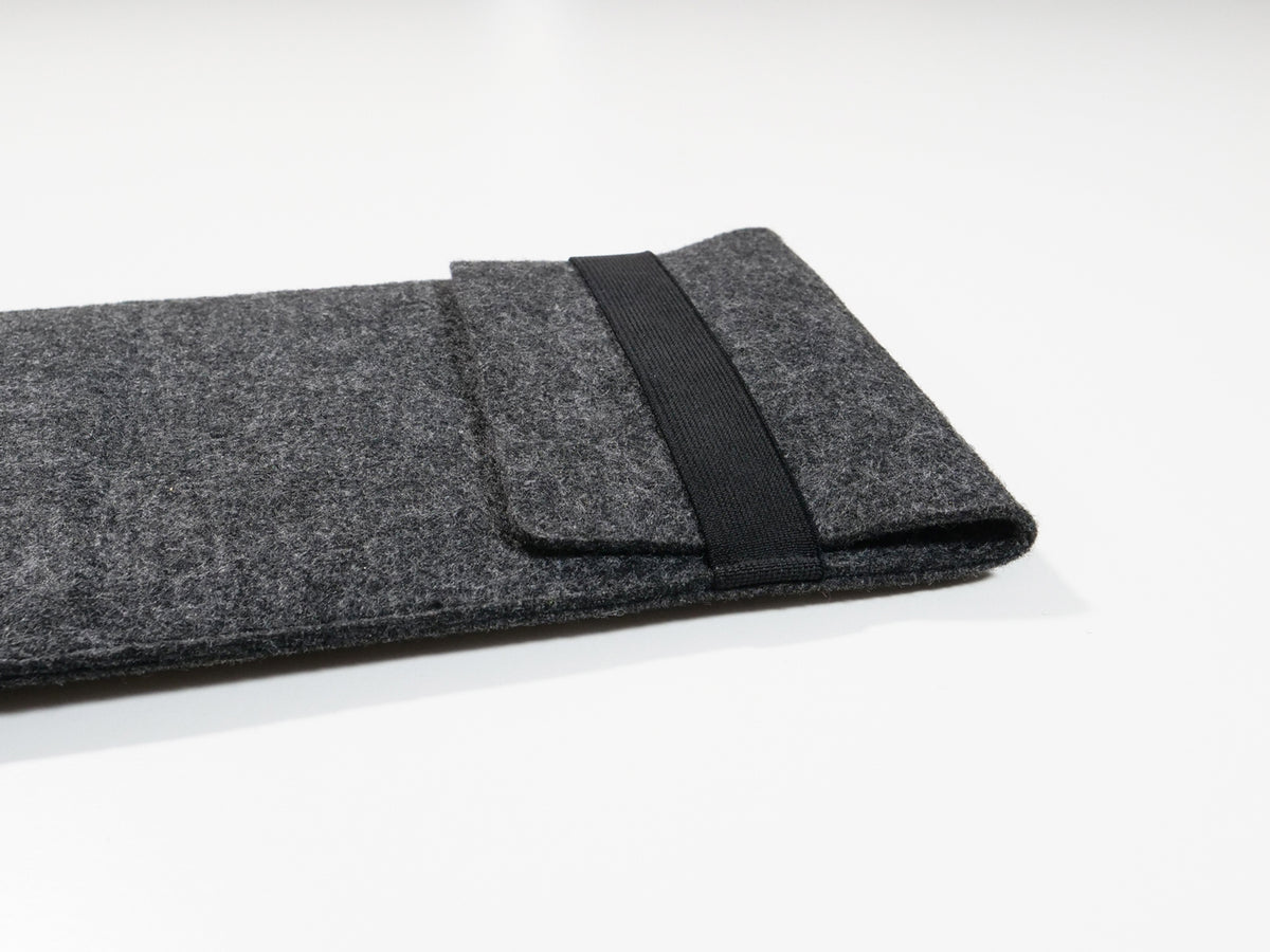 Grey felt laptop sleeve standing upright with the flap open