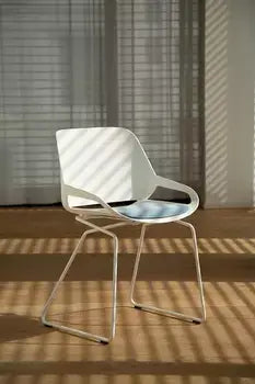 Modern white Numo active chair with sleek design and patented rocking mechanism, suitable for indoor and outdoor use.