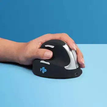 Hand resting on an HE Mouse medium left-handed wireless mouse against a blue background