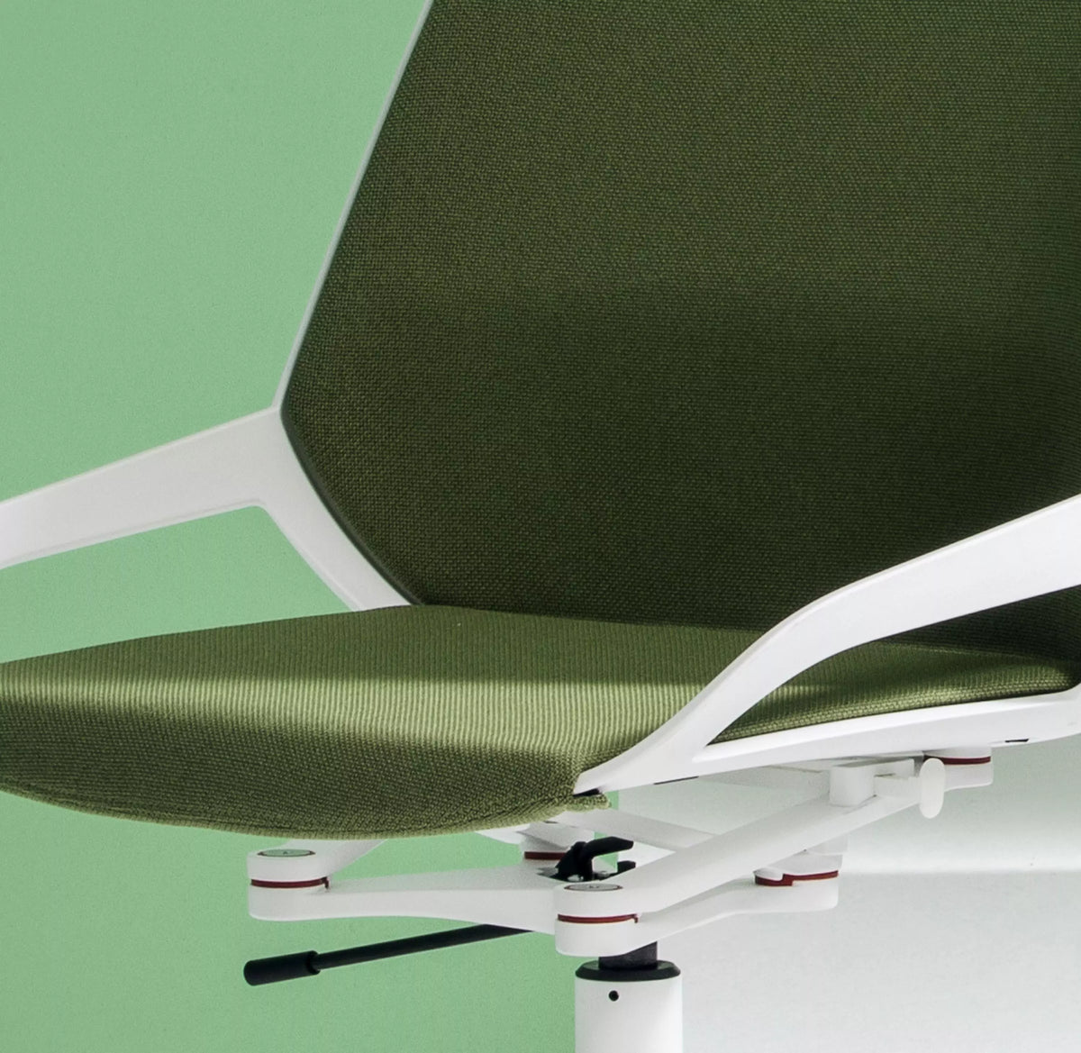 Close-up of the Numo Task active chair mechanism against a green background