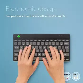 Hands typing on Ergo-R Black mini keyboard showcasing ergonomic design on a blue background.