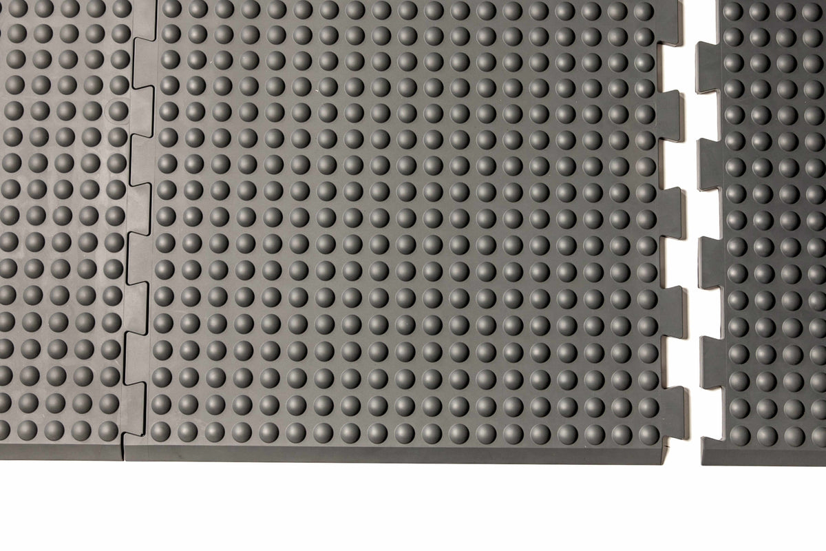 Grey GetUpMat Puzzle extension piece showing interlocking design for customizable standing mat arrangement.