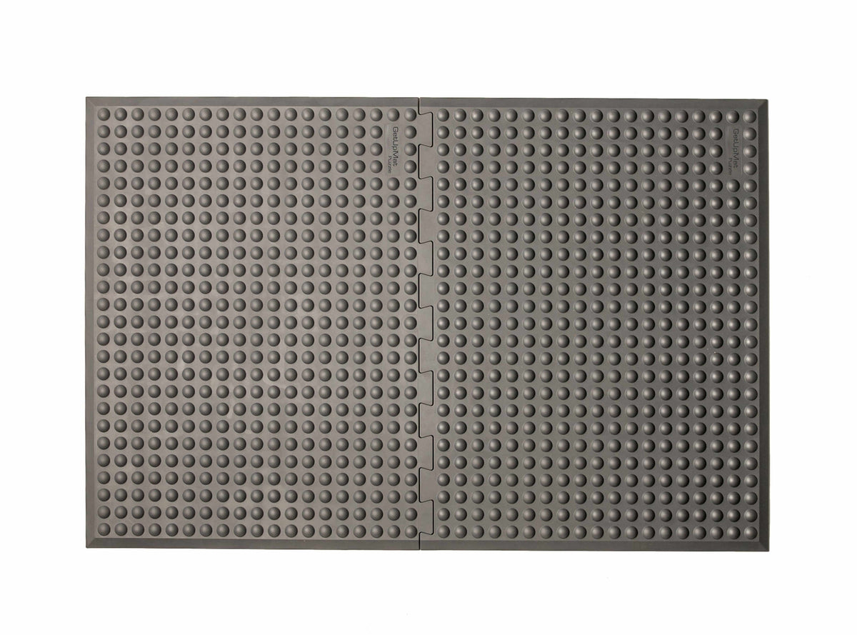 Grey GetUpMat Puzzle workstation mat for ergonomic standing, customizable length, ideal for reducing musculoskeletal strain.