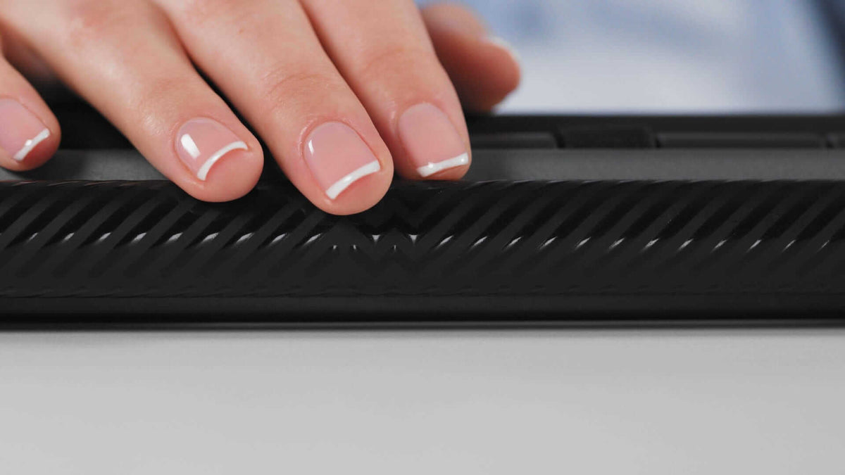 Hand resting on Mousetrapper Delta Extended black ergonomic controller with smooth design for precise navigation and comfort.