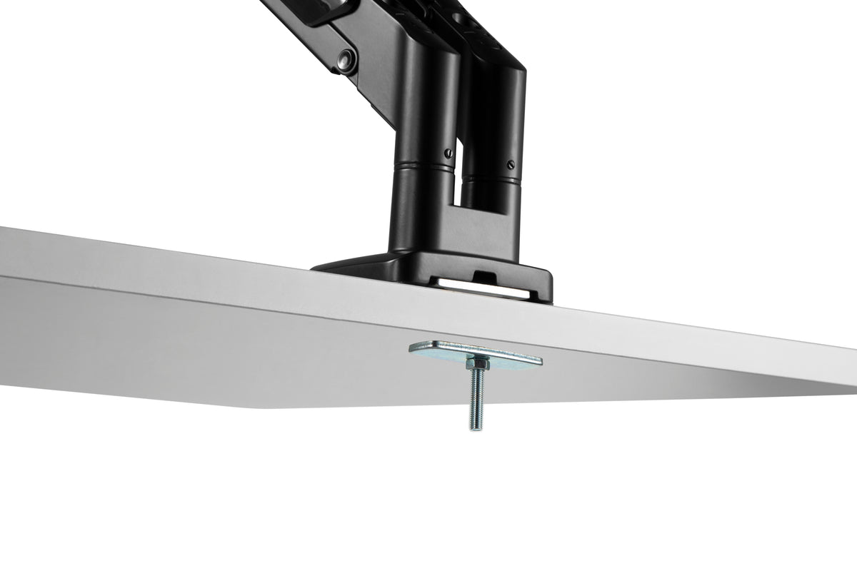 Underside view of the monitor arm grommet mount fitted through a desk