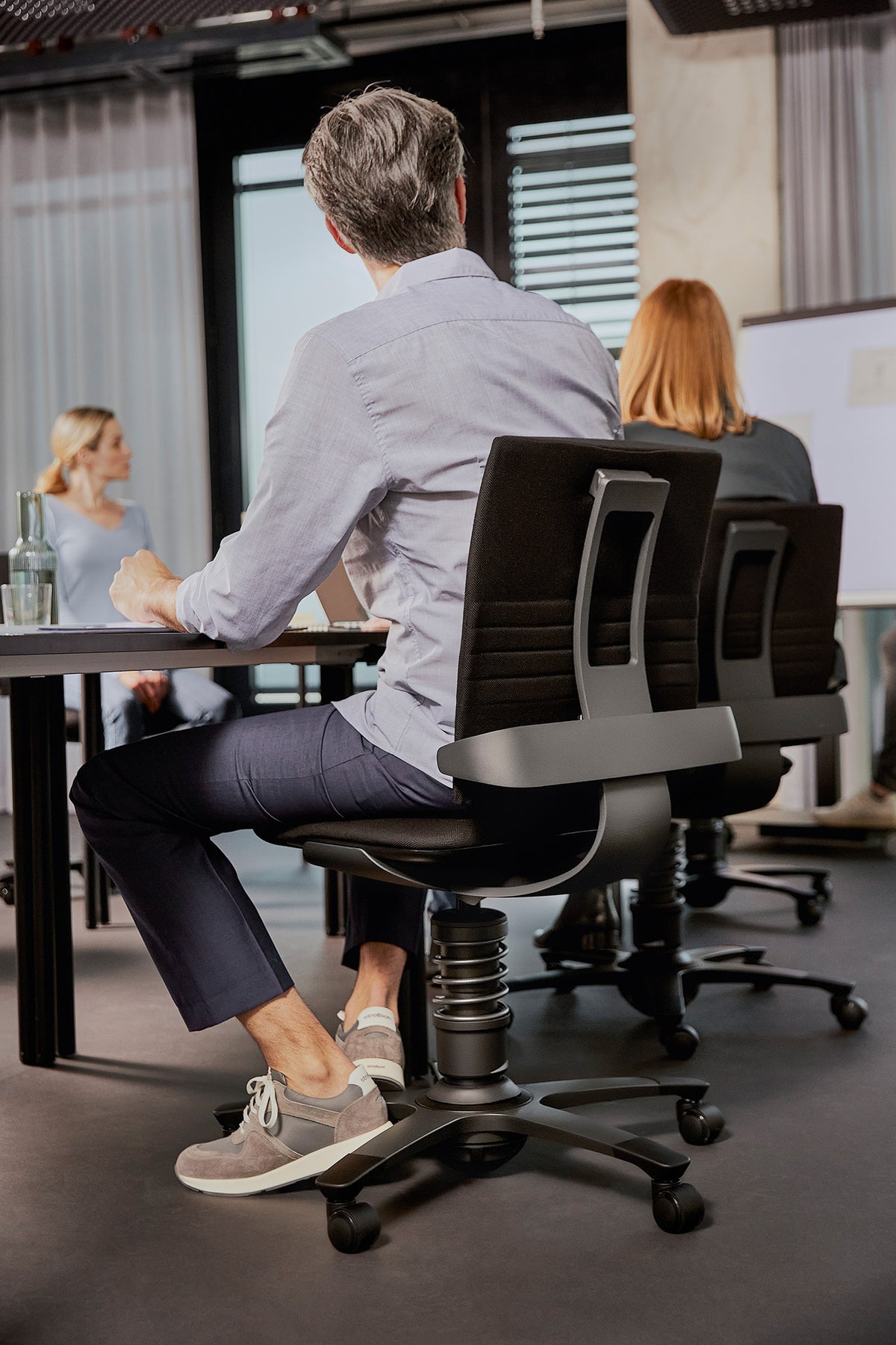 Office with colleagues working on 3Dee active chairs at desks