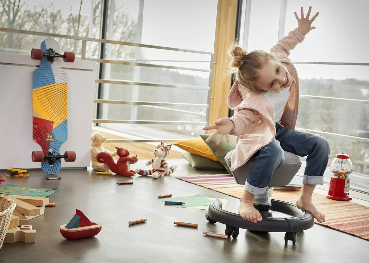 Children playing in a bright room with a Swoppster children's active chair