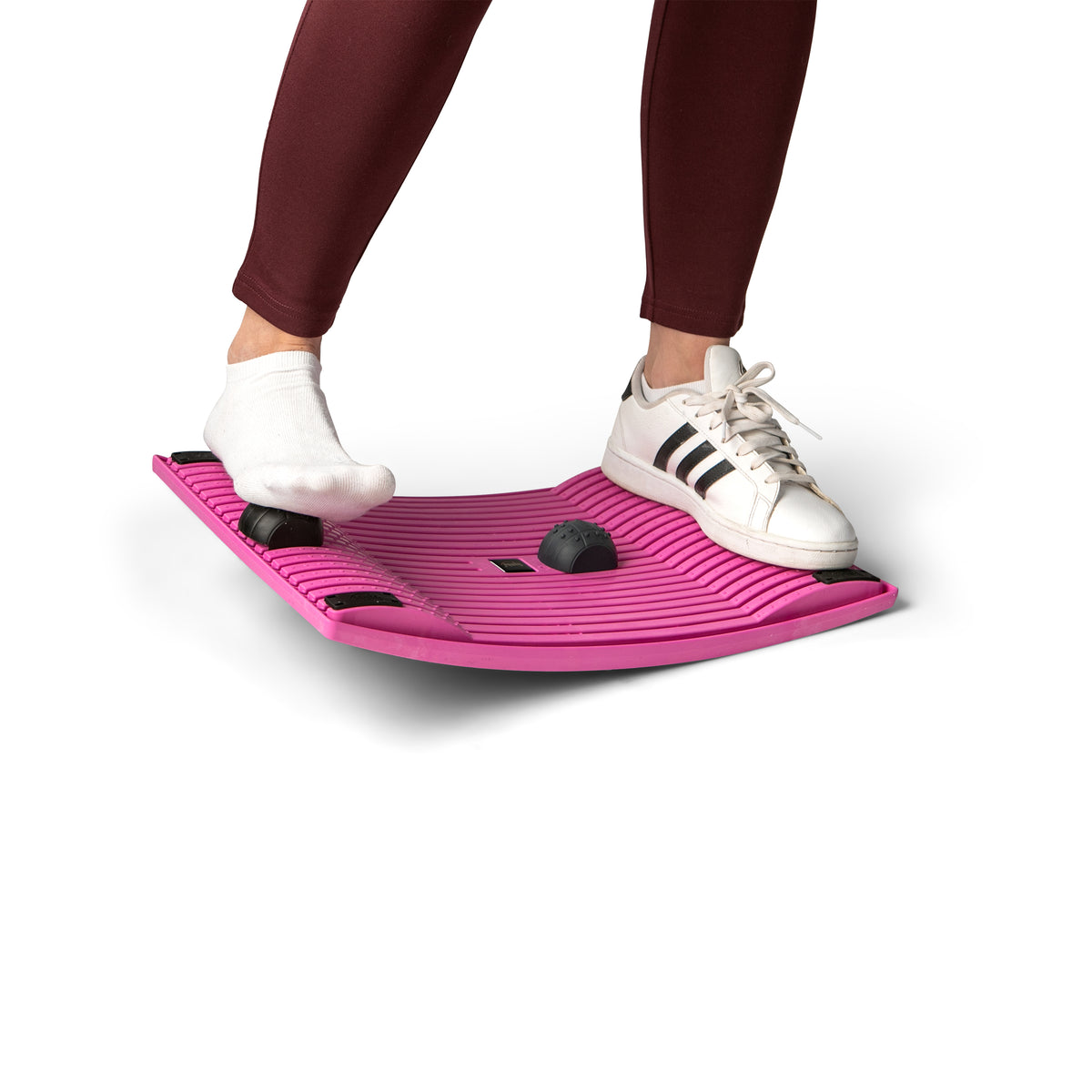 Feet in trainers standing on a pink Gymba activation board
