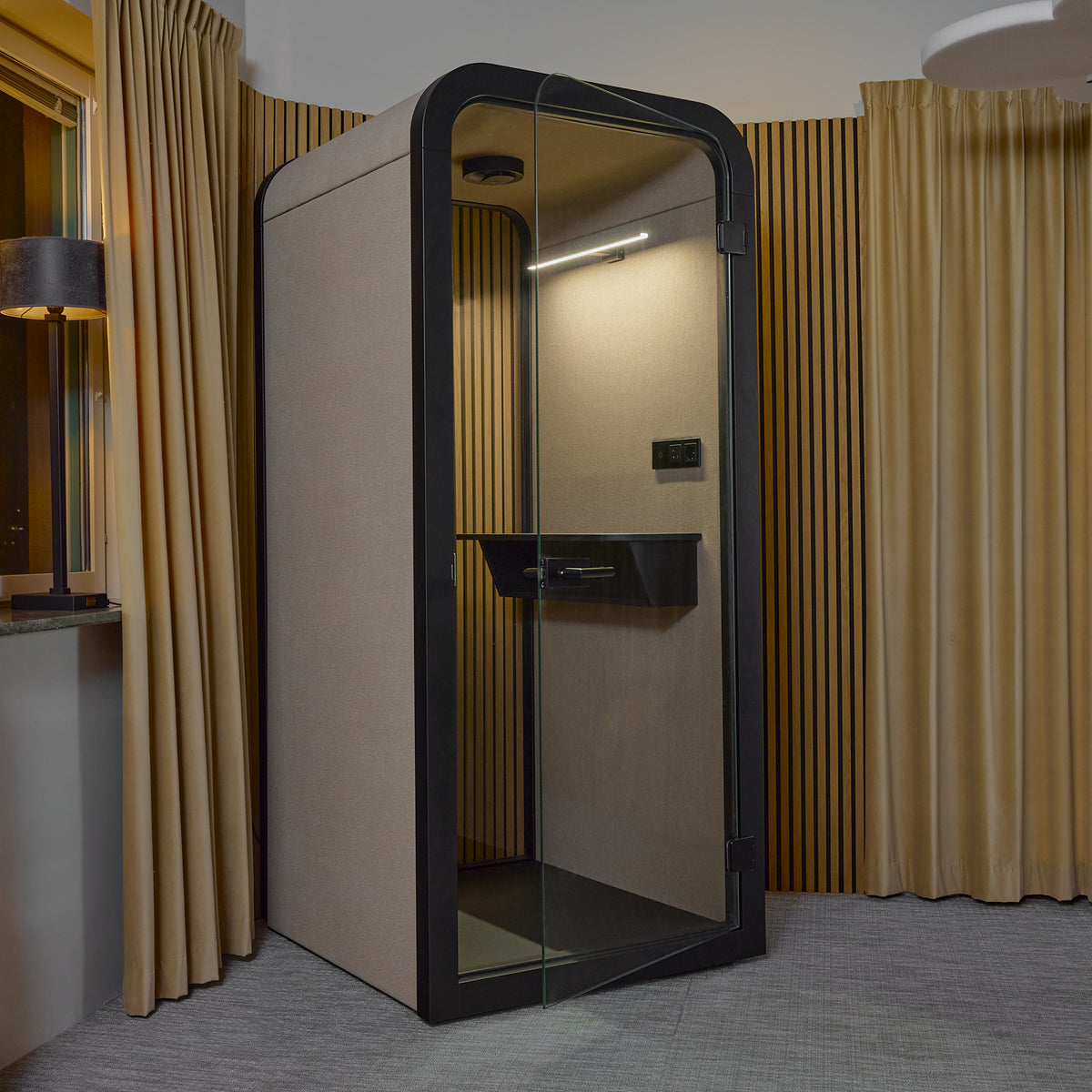 Interior of the Focus Pod phone booth with a curtain and integrated lighting