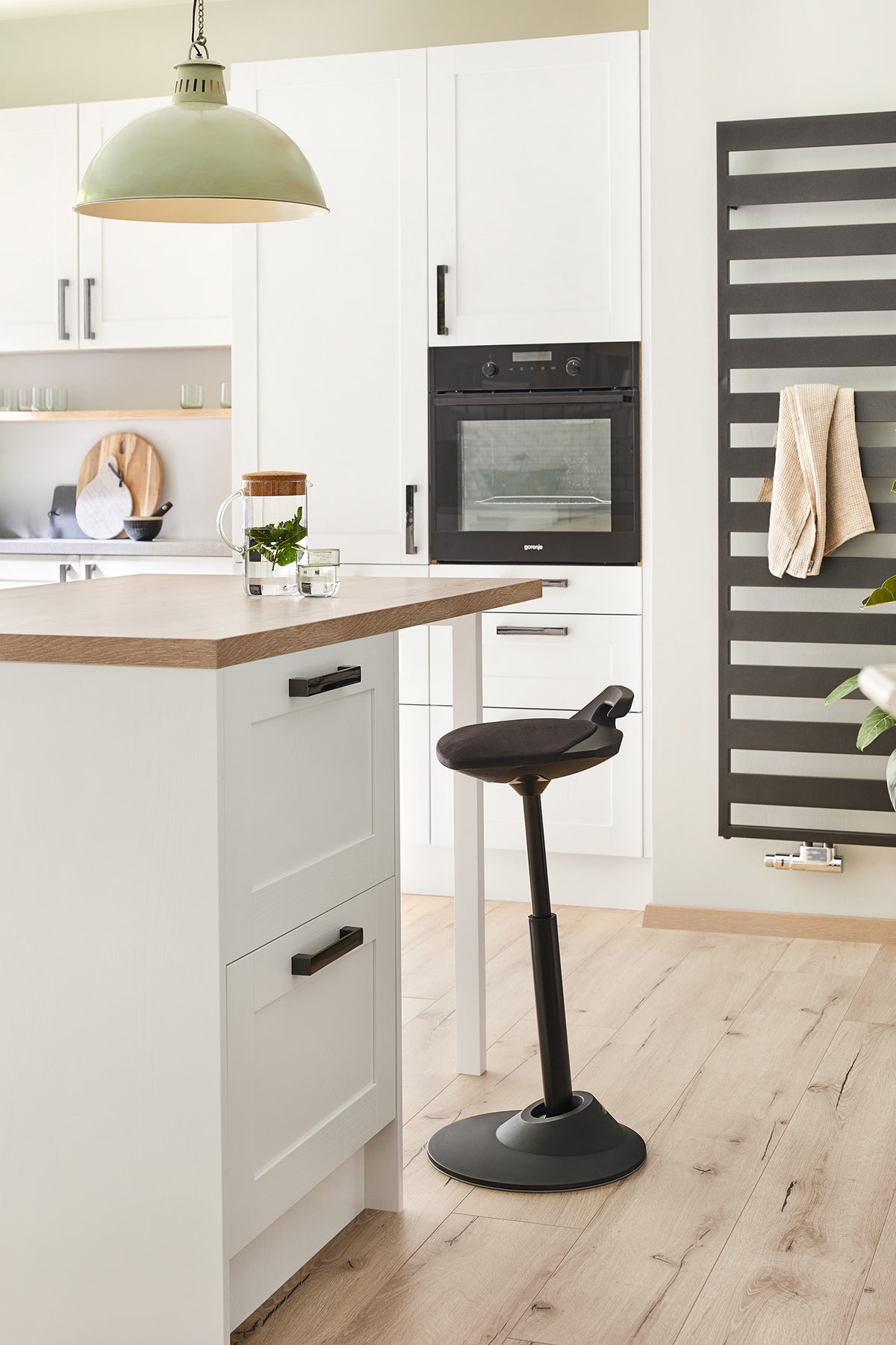 Black Muvman active stool beside a kitchen counter in a home