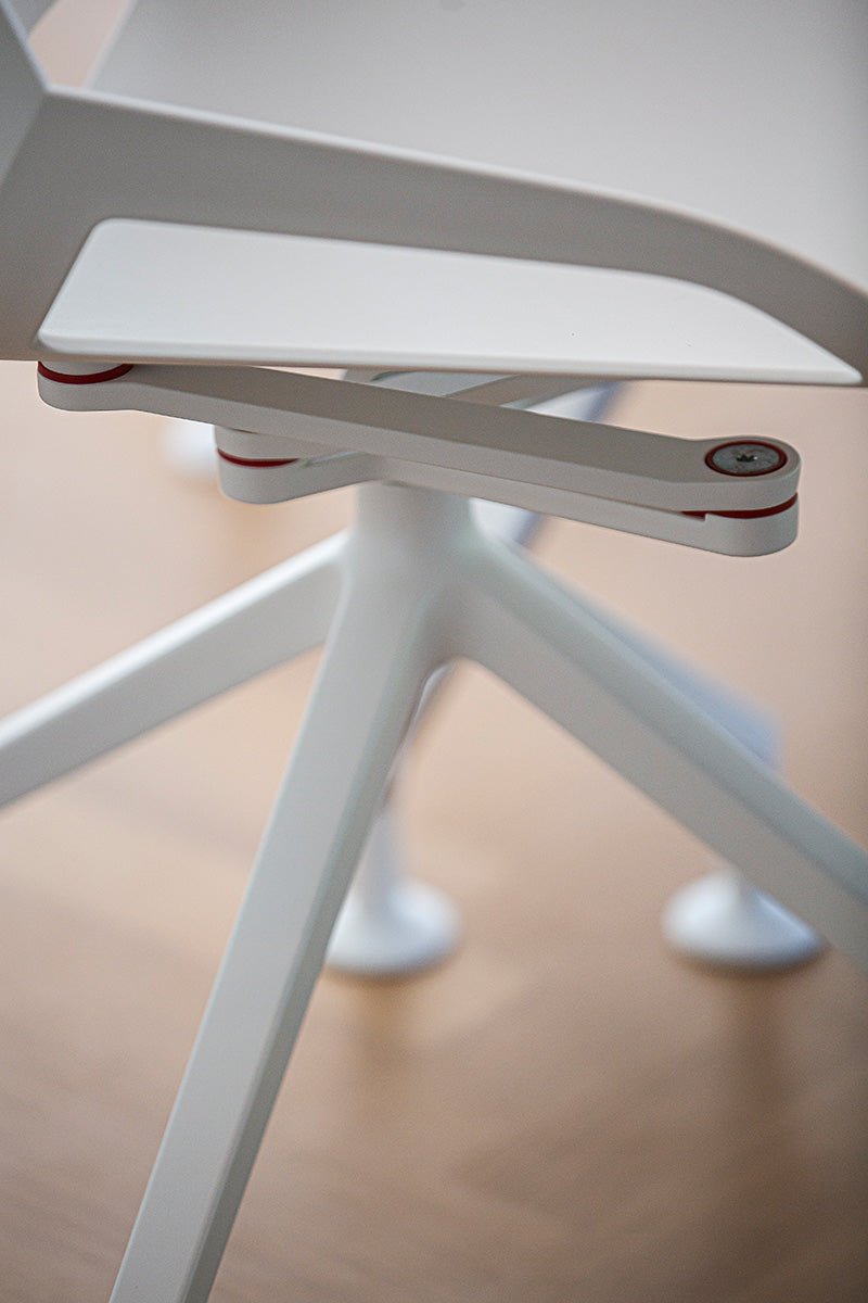 Close-up of the white four-star base and castors on the Numo active chair