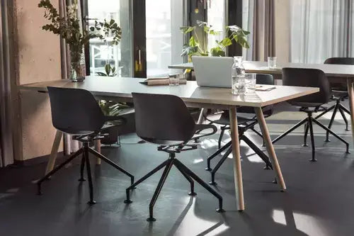 Modern office with Aeris Numo active chairs around a conference table, showcasing sleek design and ergonomic seating.