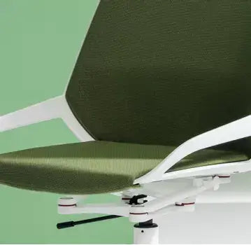 Close-up of the green upholstered seat and white shell of a Numo Task active chair