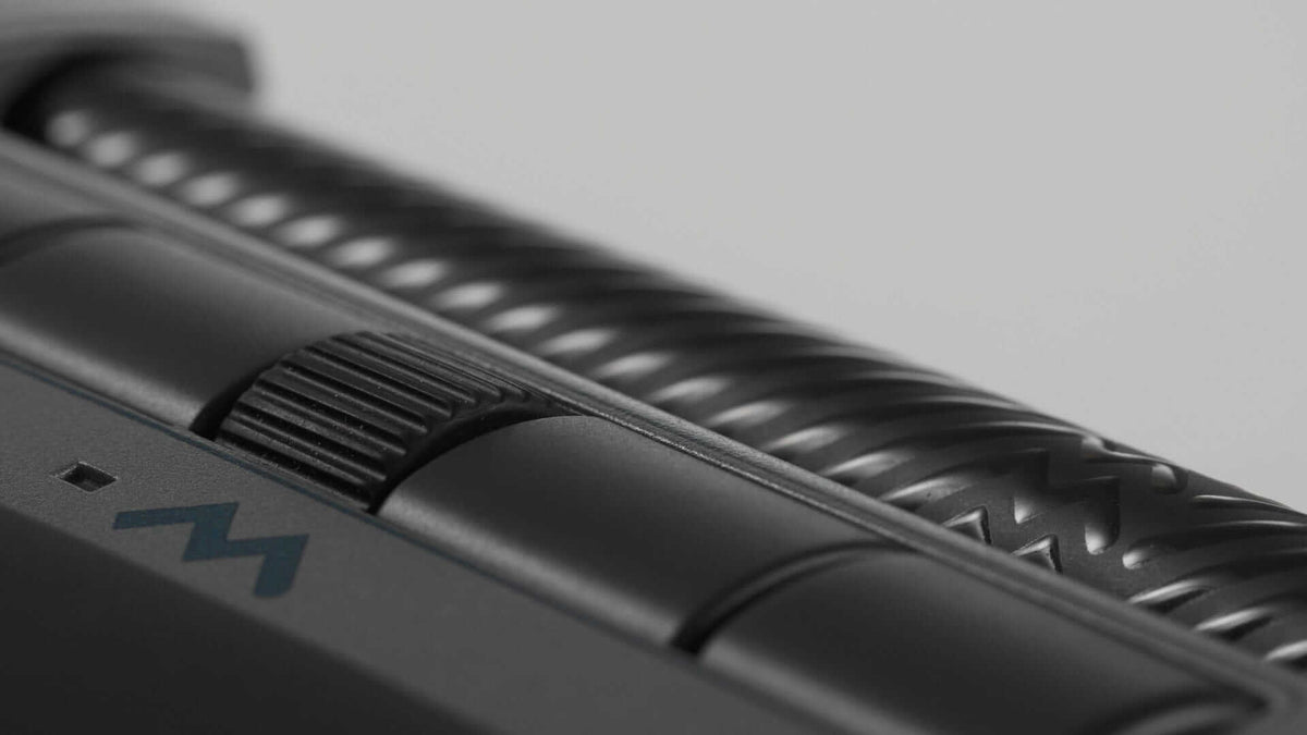 Close-up of Mousetrapper Delta Extended black ergonomic mouse with textured buttons and sleek design for precise navigation.
