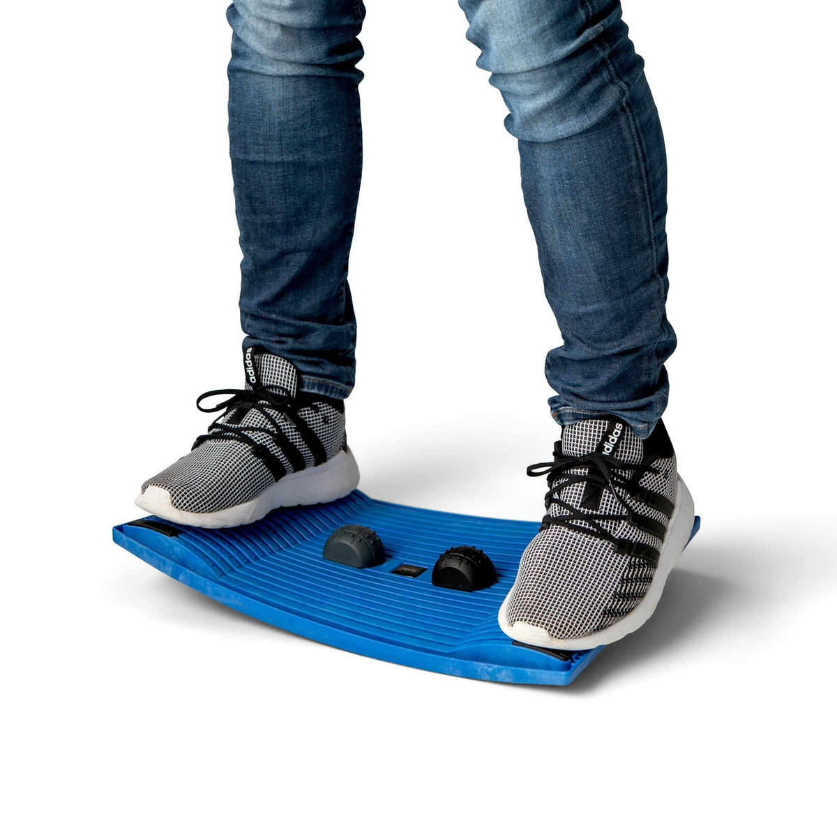 Person balancing on a blue activation board for improved movement and health at work.