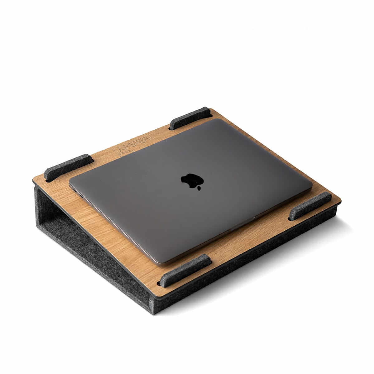 Lapsteri oak laptop stand holding a closed laptop
