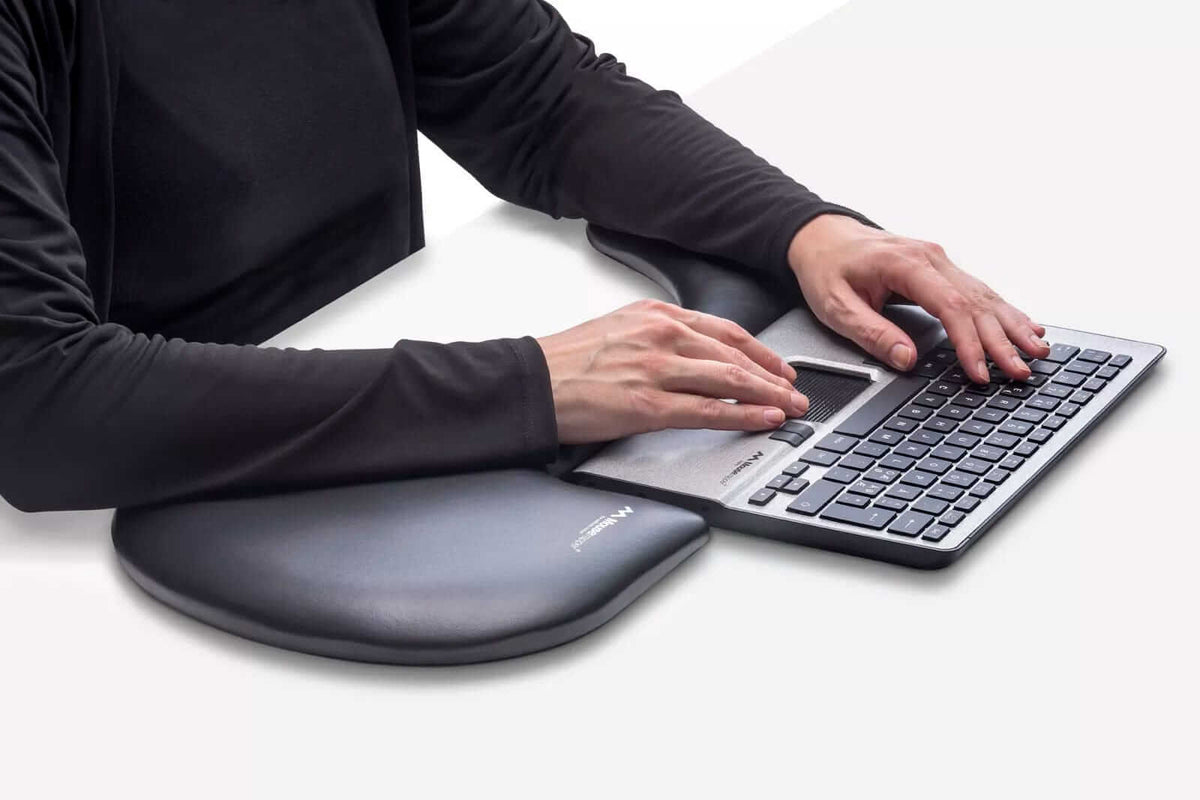 Ergonomic arm support providing comfort and reducing strain while using a keyboard, featuring an asymmetrical design for natural positioning.
